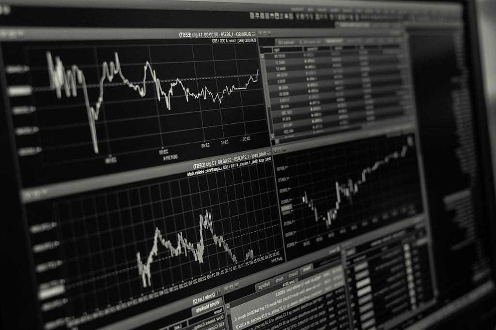 Pricing overview with charts and documents on desk
